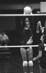Marquette volleyball player JoAnn Fischer blocks volleyball at net, 1990 by Marquette University Archives