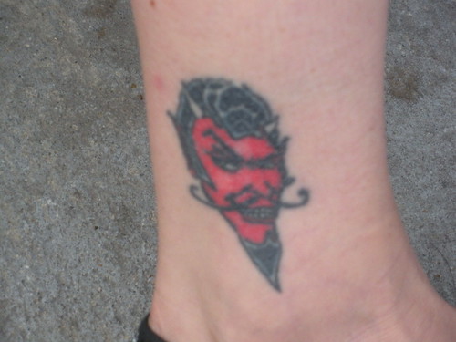 The little devil tattoo in the gallery picture shown by the red ink and