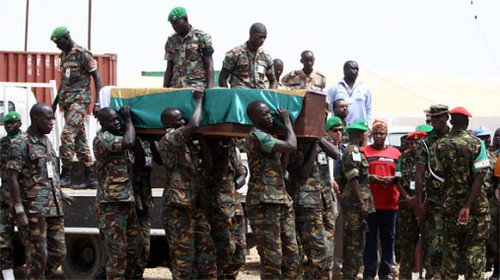 Soldiers in Sudan carry a coffin of a fallen member.