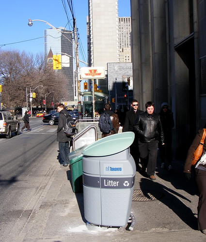 Garbage bin, S-W corner of Queen West and University