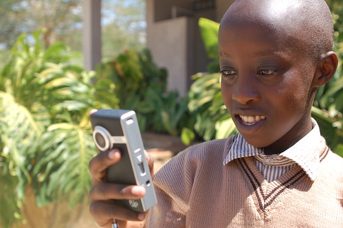 Kenyan schoolboy using a Flip camera