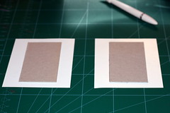 Adhering the chipboard to patterned paper