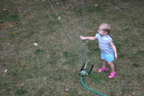 playing in the sprinkler