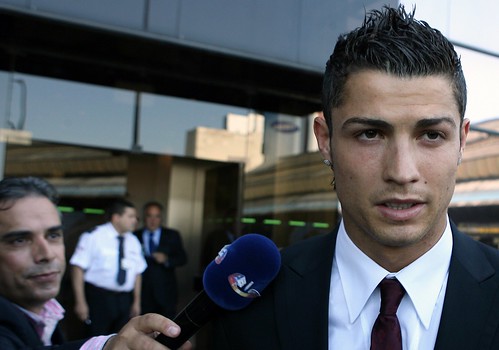 Cristiano Ronaldo is surrounded by reporters upon his arrival at Portela airport in Lisbon