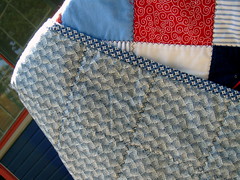 backside and binding of red blue patchwork quilt