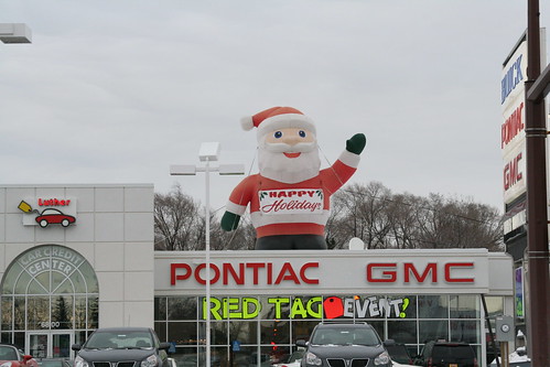 Giant Inflatable Santa Claus on the Roof of Luther Brookdale Pontiac by anglerove.