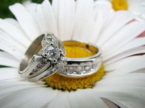 The most common ring photograph includes the rings and the brides bouquet or