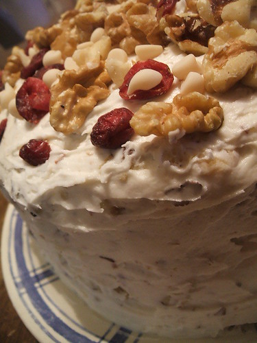 carrot cake with toasted hazelnut/cream cheese frosting decorated with walnuts,cranberries and white chocolate chips