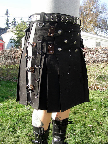 Punk Kilt 3/4 view. A custom made kilt featuring 100% black cotton base with silver rivets, silver-detailed buttons, leather accents and 21 d-rings. 2011