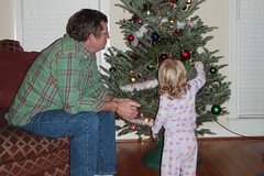 Catie pointing out her favorite ornaments to Grandpa Roger