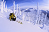 A skier in the powdery backcountry with a scenic view at Whitewater Ski Resort, British Columbia