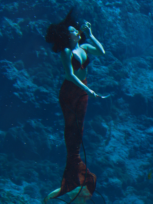 a Weeki Wachee mermaid demonstrates drinking under water, Florida