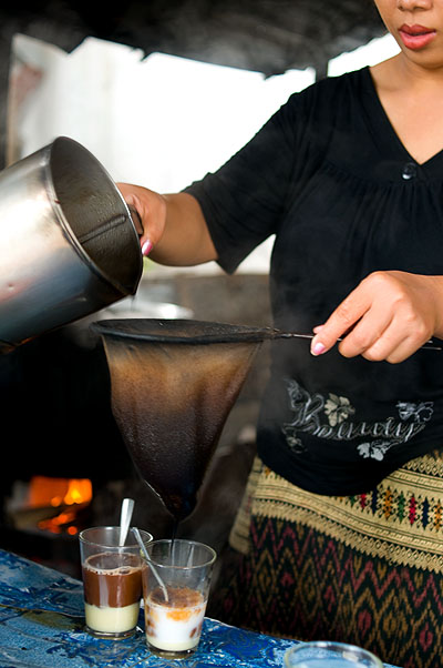 Making coffee Lao-style at Pasaneyom Coffee Shop, Luang Prabang