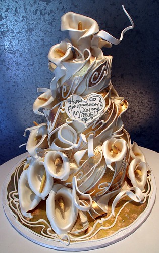 All edible tiered cake with 24 ct gold wrapping around the cake with white 