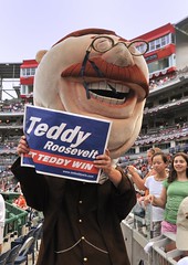 Washington Nationals racing presidents Teddy Roosevelt at Nationals Park holding up a Presidents Race Rally Sign from LetTeddyWin.com.