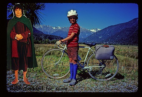 1985 standing by bike with hobbit