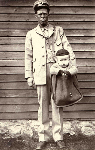 Uniformed Letter Carrier with Child in Mailbag, by Unidentified photographer, c. 1900, National Post