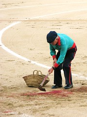 Scooping blood soaked sand, Madrid, Spain