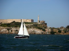 A sail boat passed by Alcatraz Island