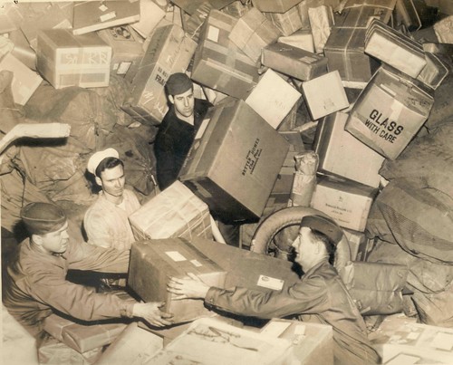 U.S. Troops Surrounded by Holiday Mail During WWII, by unidentified photographer, c. 1944, National 