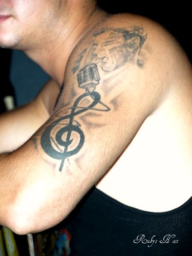 musical tattoo. Musical notes and singer arm