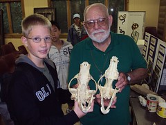 Alexander and Mr Preston, holding a bear skull (left) and wolf skull (right)