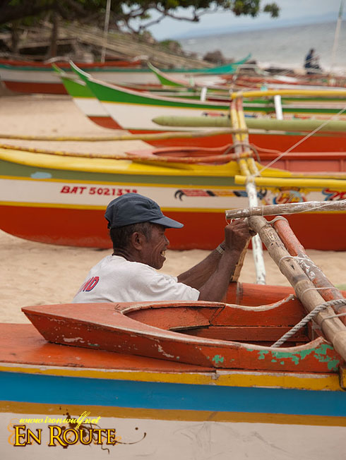 A Fisherman tightening the boat rig knots