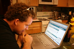 Kevin checking his news in Katie's kitchen
