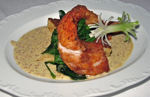 Panneed Rabbit Tenderloin on a Tasso-Parmesan Grits cake with Sauteed Spinach and Creole Mustard Sauce