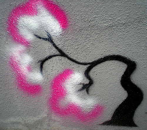 Albequerque graffiti of a tree with a pink and white, bent nearly to the ground 