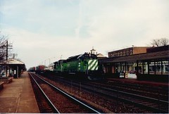 Speeding westbound Burlington Northern freight train. Western Springs Illinois. April 1989.