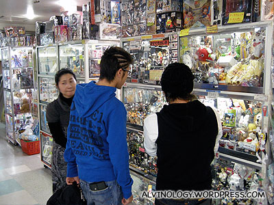 Japanese teens checking out plastic figurines