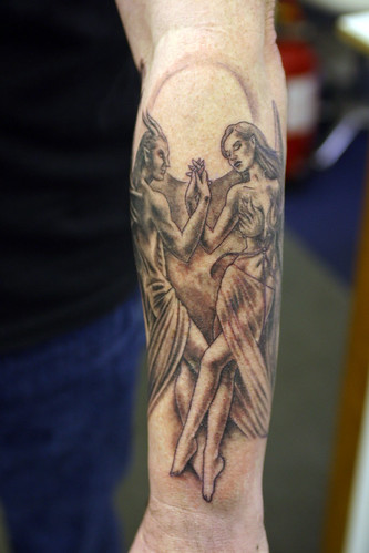 Angel-dancing-with-the-devil Tattoo by The Tattoo Studio.