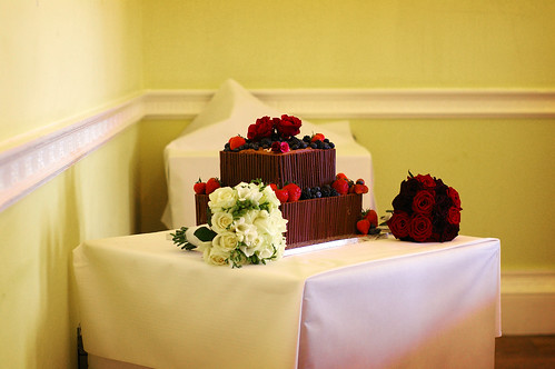 A truly lovely chocolate wedding cake The red roses are wonderful accents 