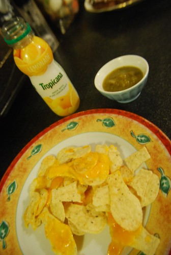 Corn chips with cheese green salsa and lemonade