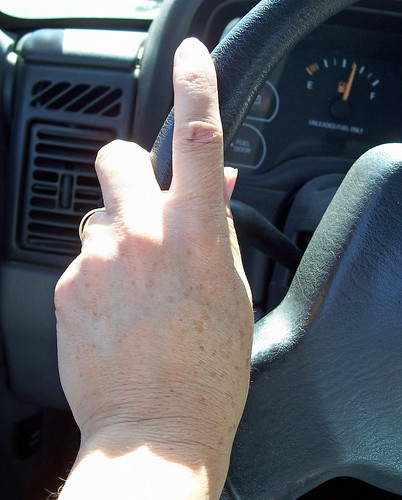Hand on steering wheel by cheerytomato.