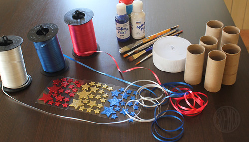 supplies for patriotic streamers (ribbon, paint, star stickers, empty toilet paper rolls)