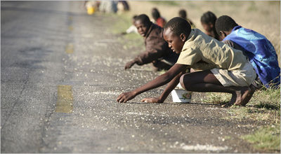 children in Zimbabwe scavenging for rice