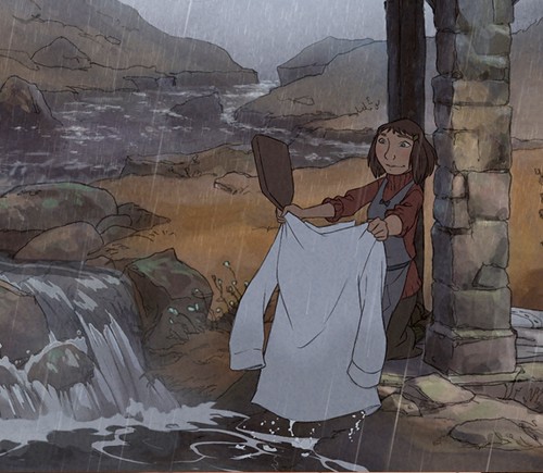 "L'illusionniste"'s Alice, a small, blunt-cut-brown-haired girl with dark clothes and an apron, washes a white shirt in a lake while it rains. Image via empireonline.com.