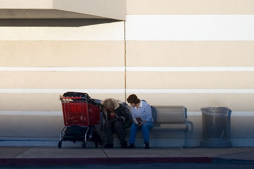 boy with book talking to a homeless man outside Target