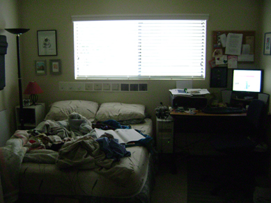 unmade bed and desk