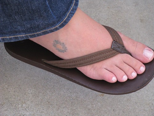 small flower tattoos on foot. Flower foot tattoo