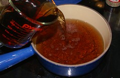 strain liquid from boiling hulls into saucepan
