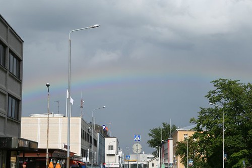 man walking under the rainbow