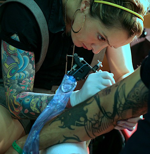 Woman Tattoo Artist art designs with flower tribal Tattoo Festival 