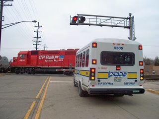Pace paratransit bus halted by a Canadian Pacific switching local. Franklin Park Illinois. January 2007.