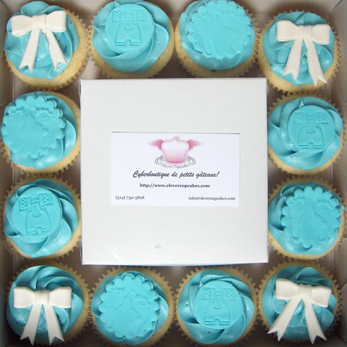 I love how the white bows on the tiffany blue vanilla frosting makes these