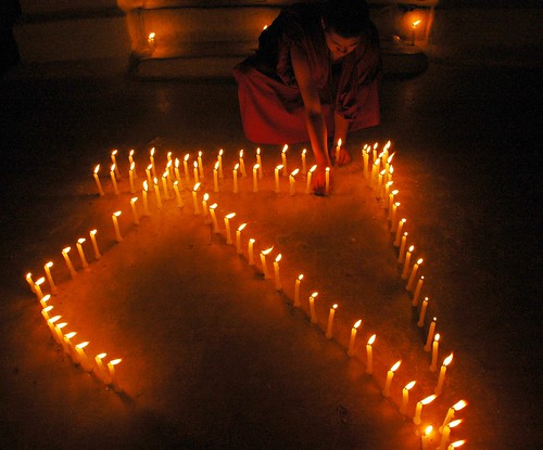 "S" or "sa" in Tibetan, spelled out in candle offerings, celebration of Sakya, Boudha stupa, night, Boudha, Kathmandu, Nepal by Wonderlane