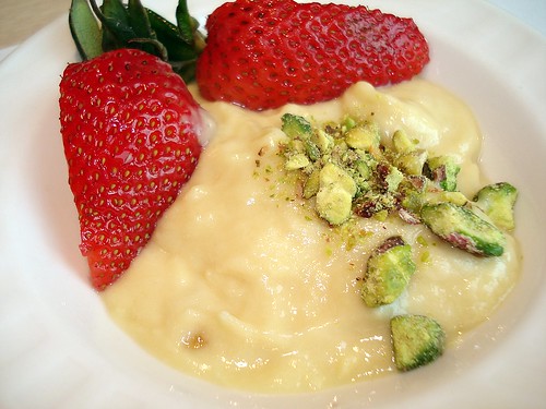 Durian pengat, decorated with strawberry and chopped pistachios