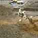 Looking north across Zone 2; Tom in a soak-away, Lukasz clearing modern drains